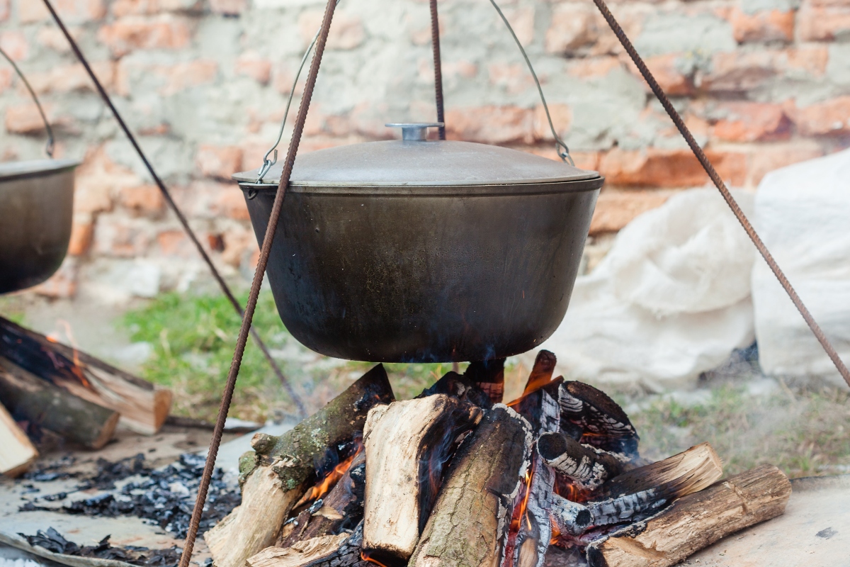 black cauldron over a wood fire