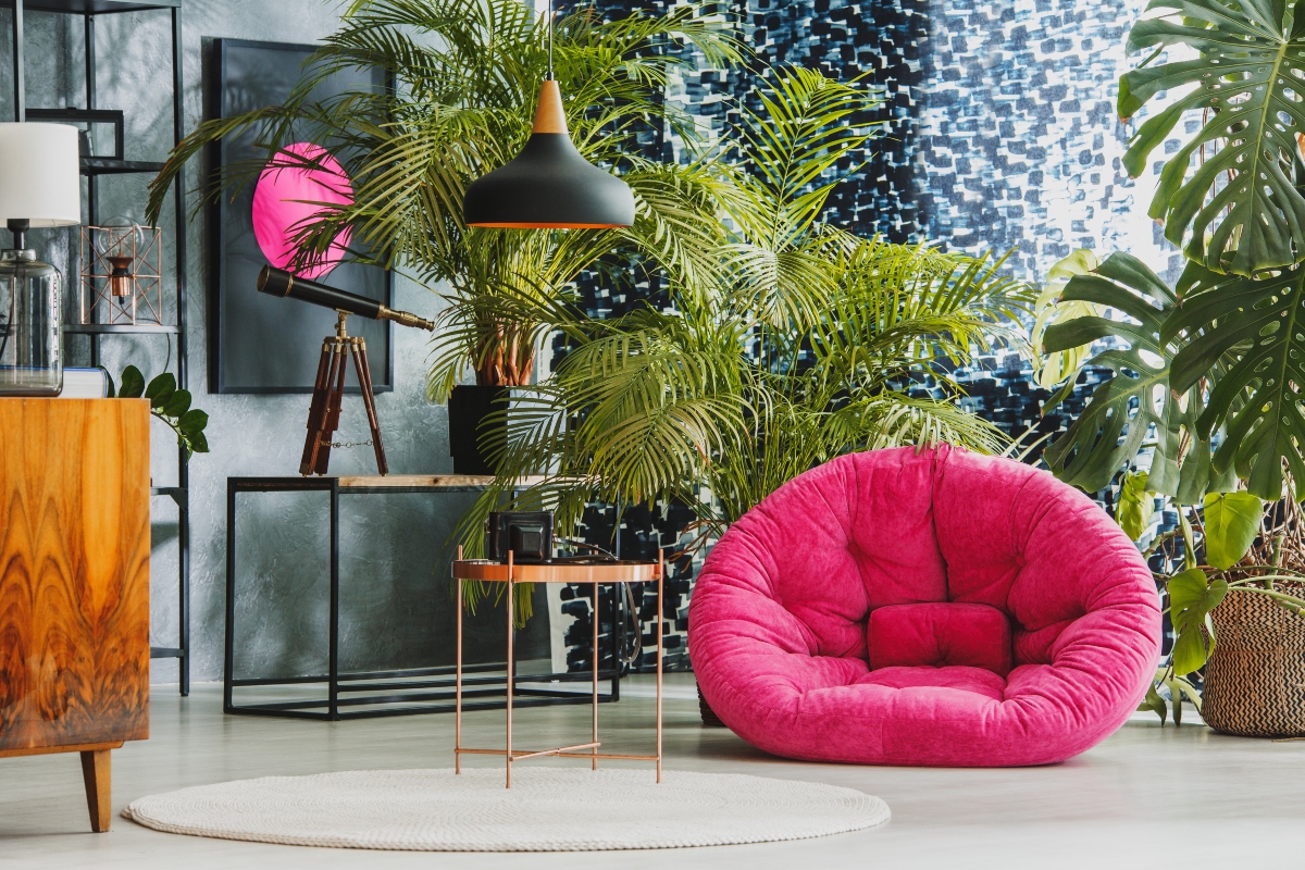 bright pink chair and printed wall art in maximalist room