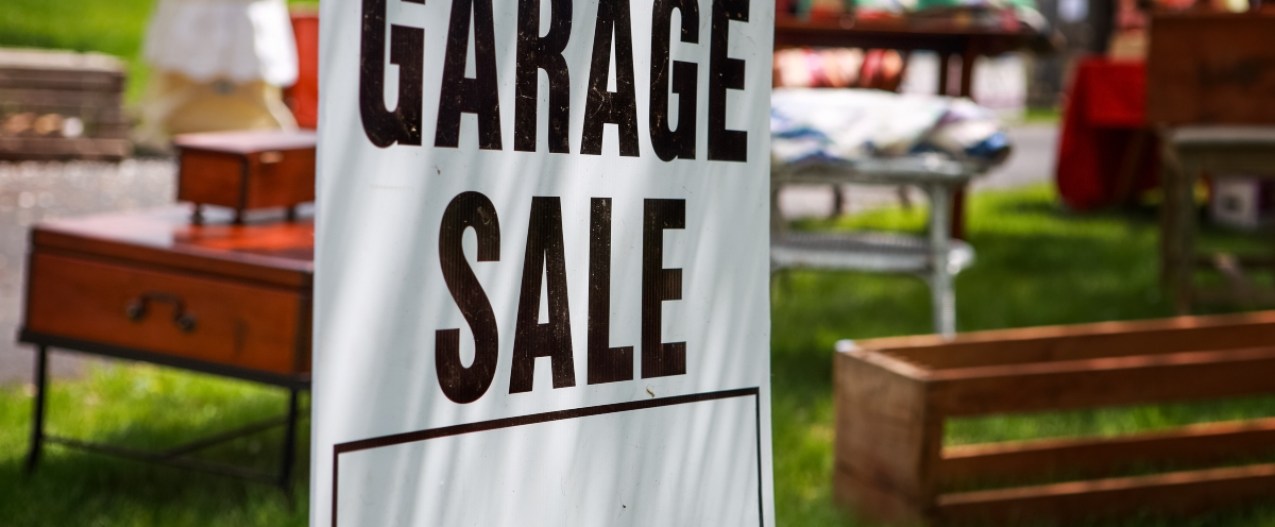 Garage sale sign in front yard
