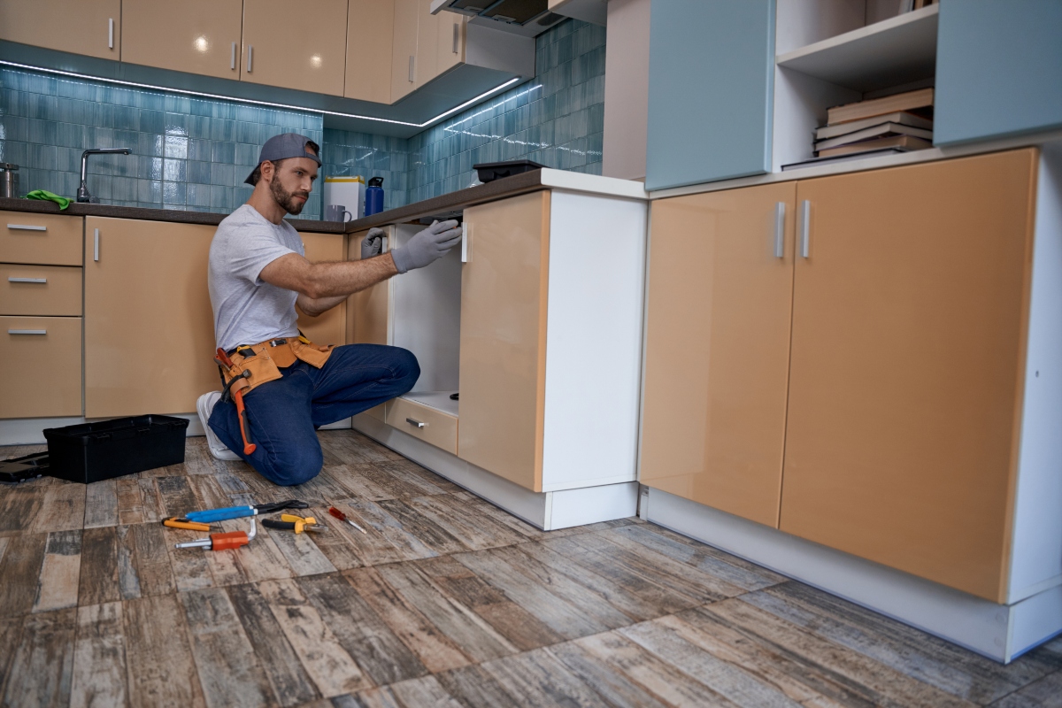 man remodeling kitchen cabinets