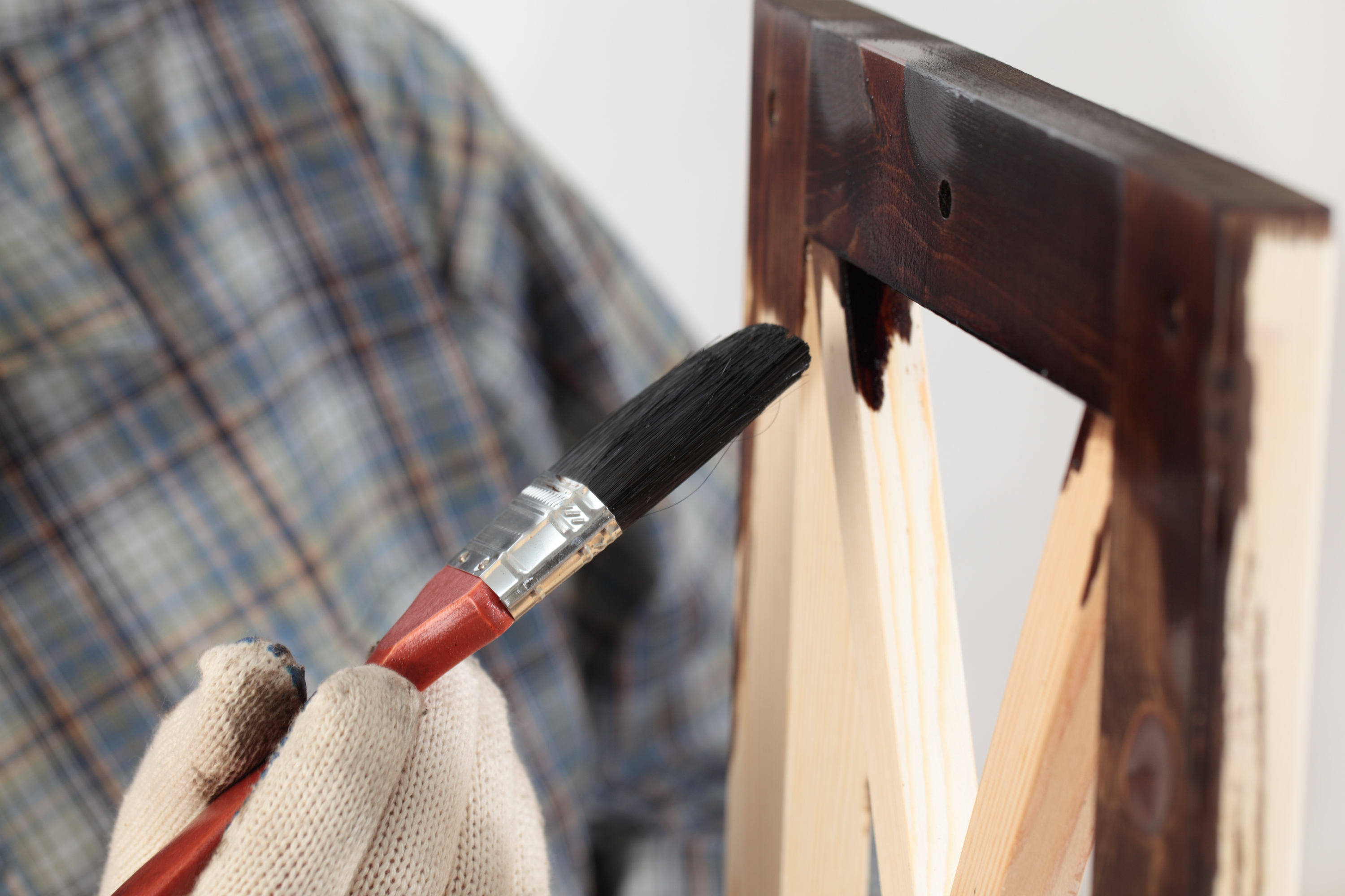 Man with glove and paintbrush