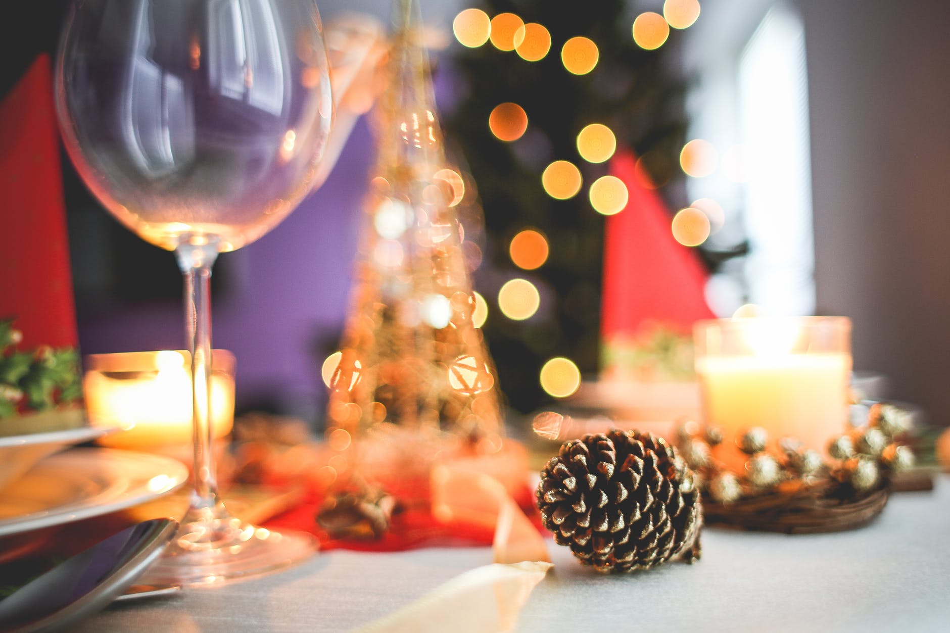 Holiday party with wine glass and pine cone