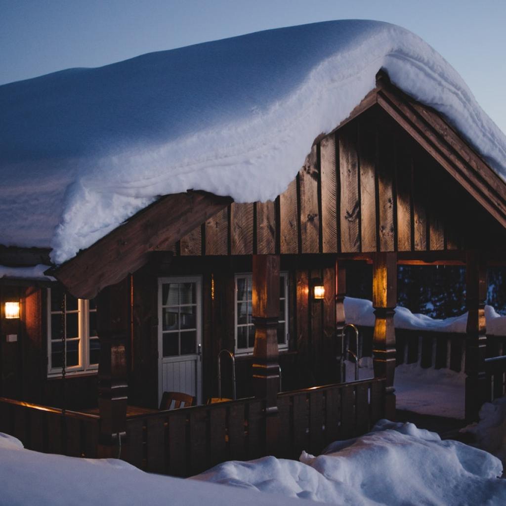 Remote wooden house with heavy snow