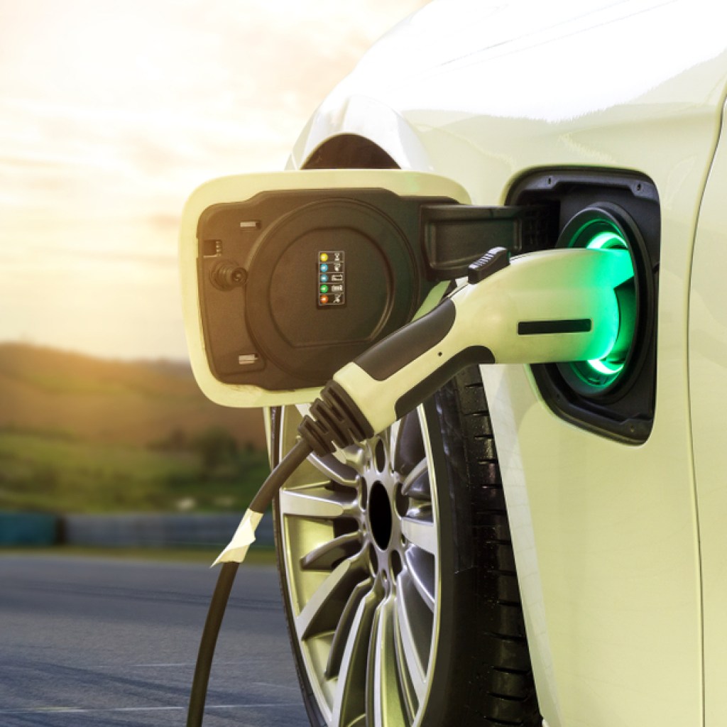 White electric vehicle charging port with charger connected