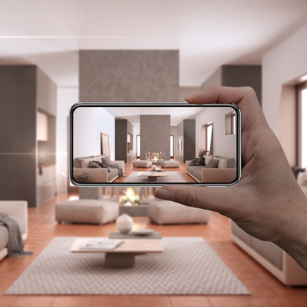 Person holding a smartphone for AR home decor
