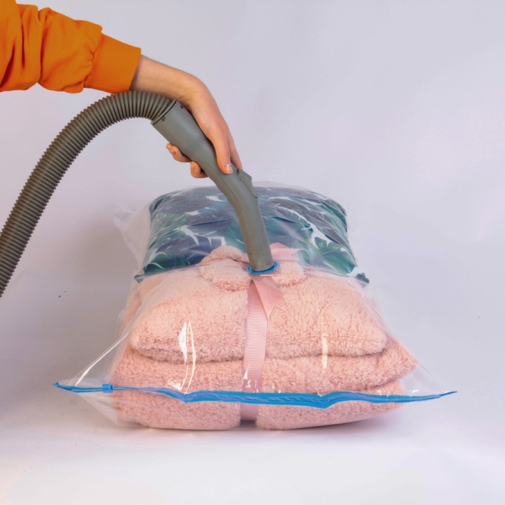 Person vacuum sealing clothing