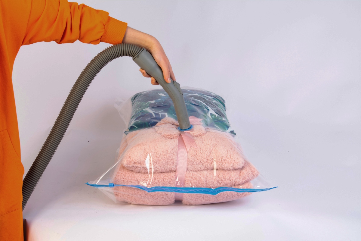 Person vacuum sealing clothing