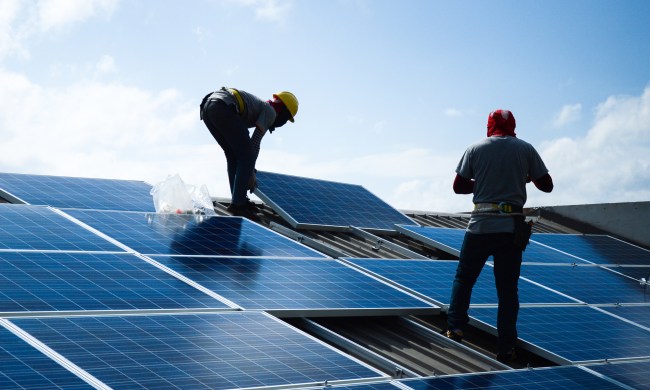 Workers installing solar panels