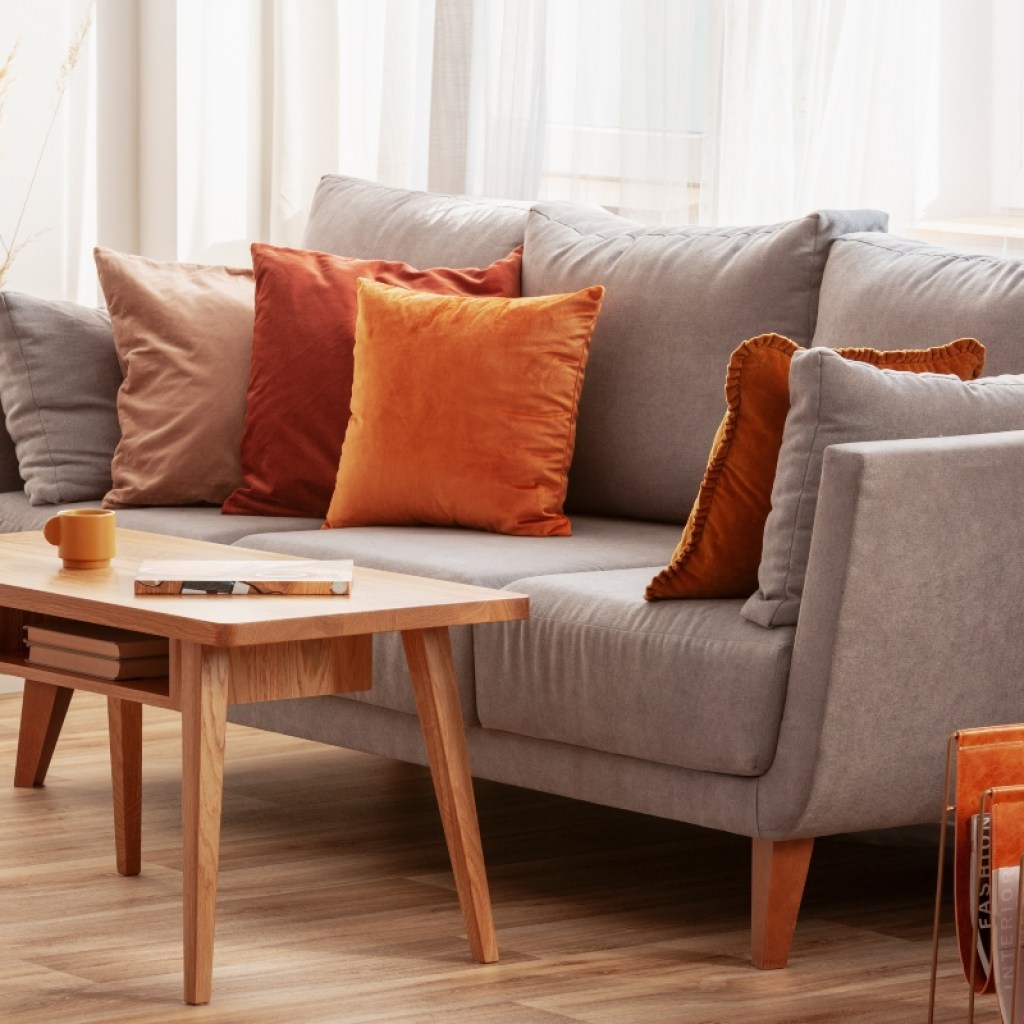 autumn decor and red and orange cushions on sofa in living room