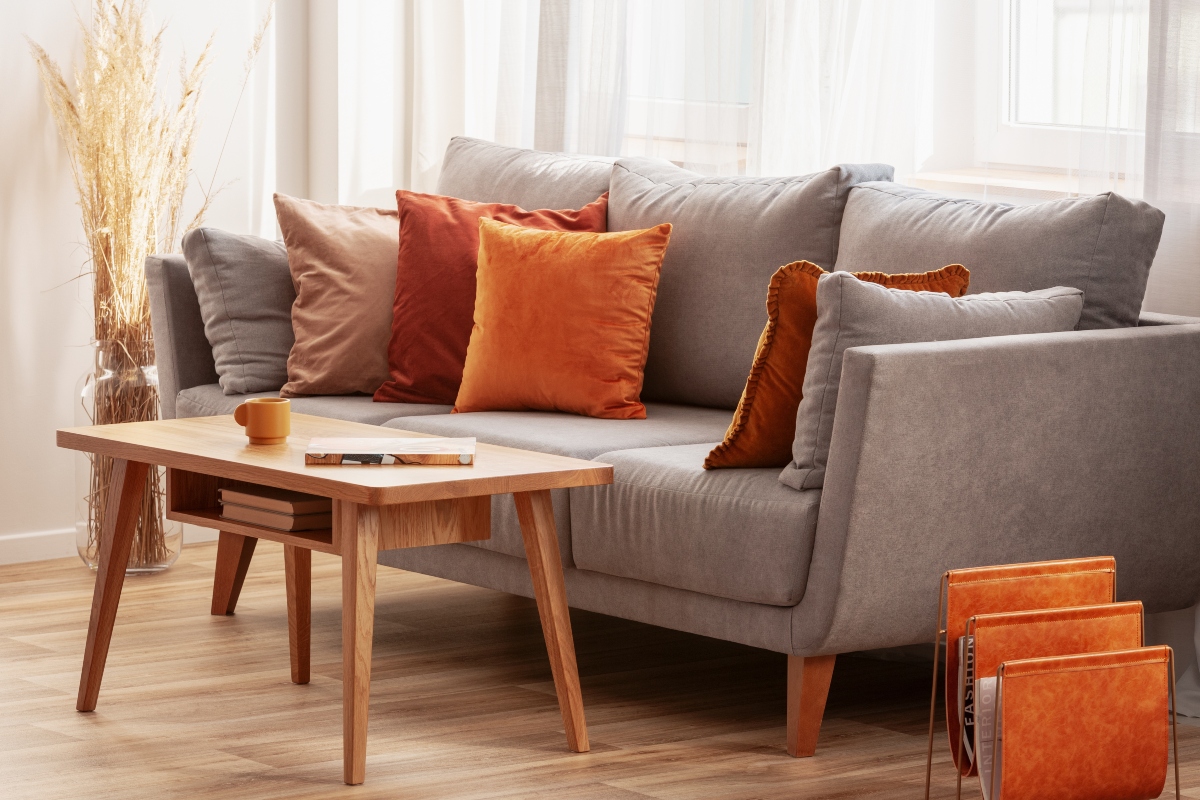 autumn decor and red and orange cushions on sofa in living room