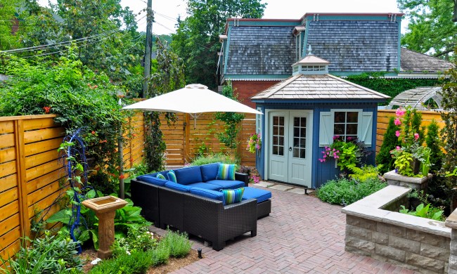 Backyard patio with pavers, plants, and furniture