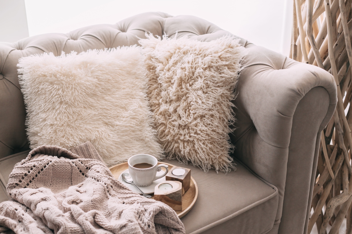 comfy pillows and blankets on couch hygge design