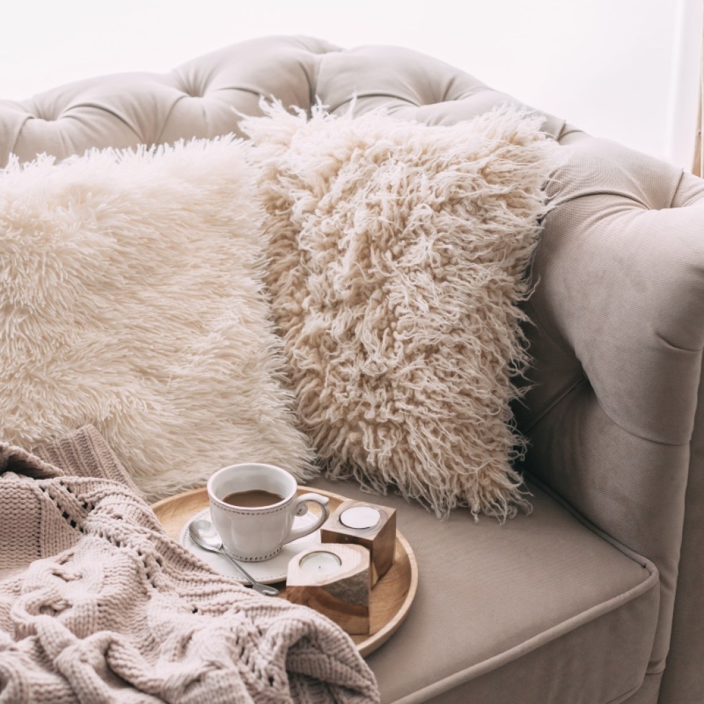 comfy pillows and blankets on couch hygge design