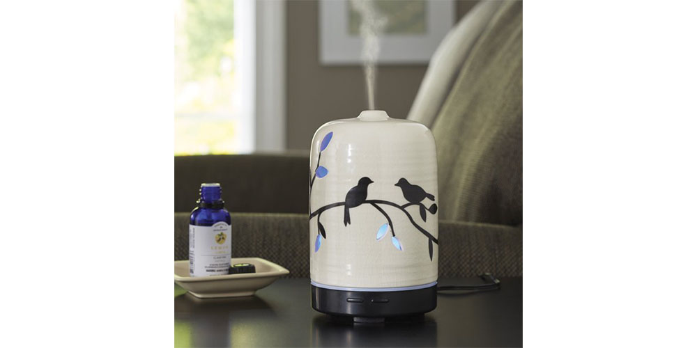 Better Homes & Gardens Essential Oil Diffuser placed on a countertop in a living room.