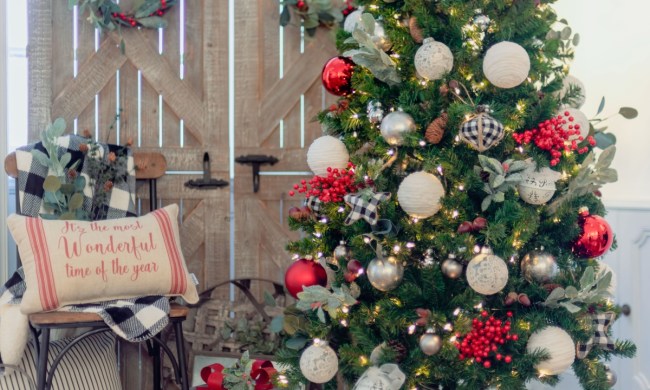 Farmhouse-styled Christmas tree with pillows and chairs as decor