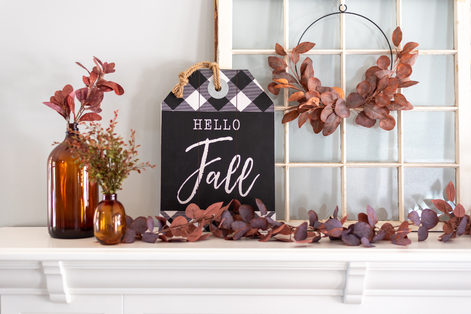 Fall mantle decor leaves and sign.