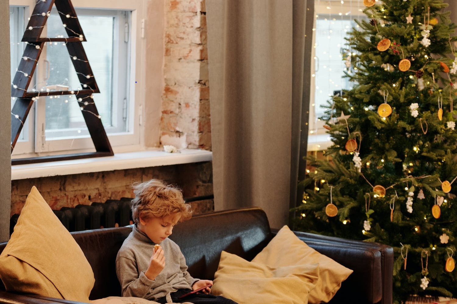 child on couch – Christmas tree