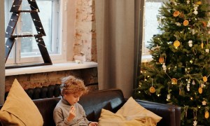child on couch – Christmas tree