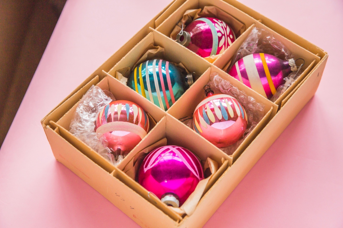 Colorful pink Christmas ornaments in a box