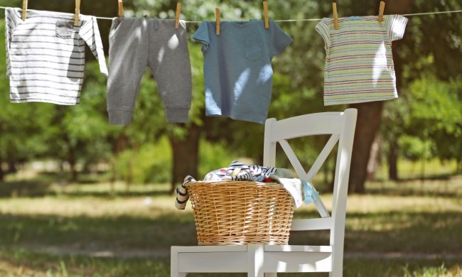 Clothes drying on a line next to a white chair and wicker basket