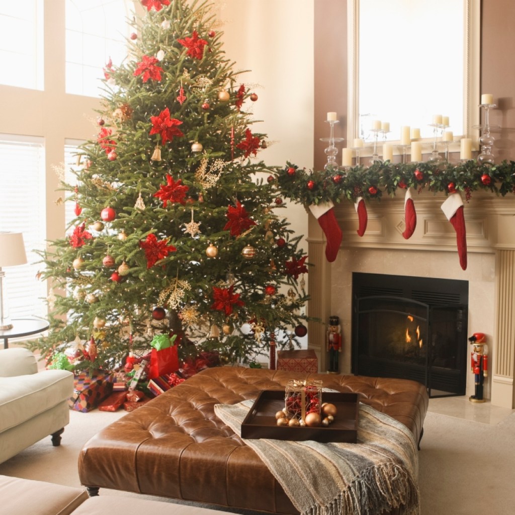 traditional styled christmas decor on fireplace mantle with tree
