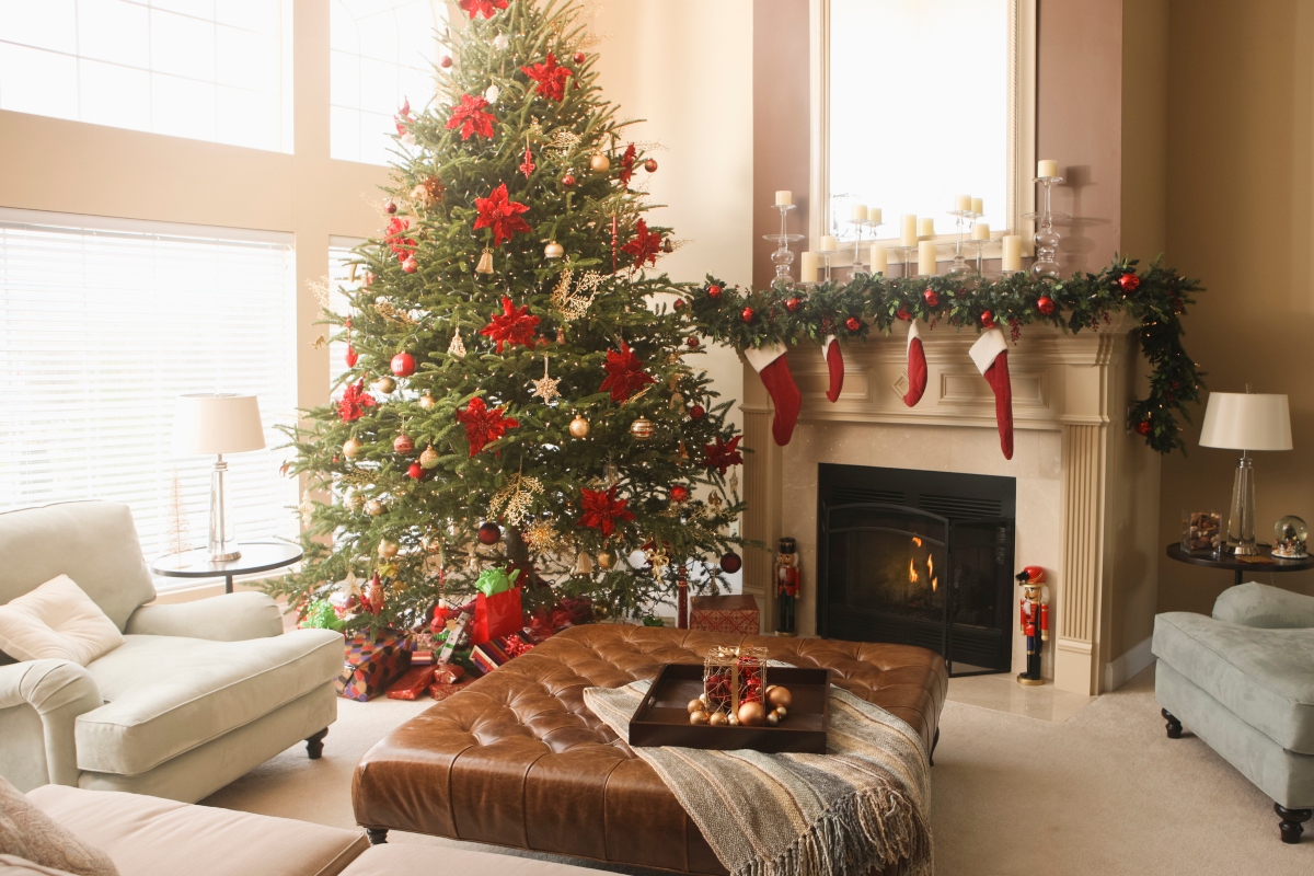 traditional styled christmas decor on fireplace mantle with tree