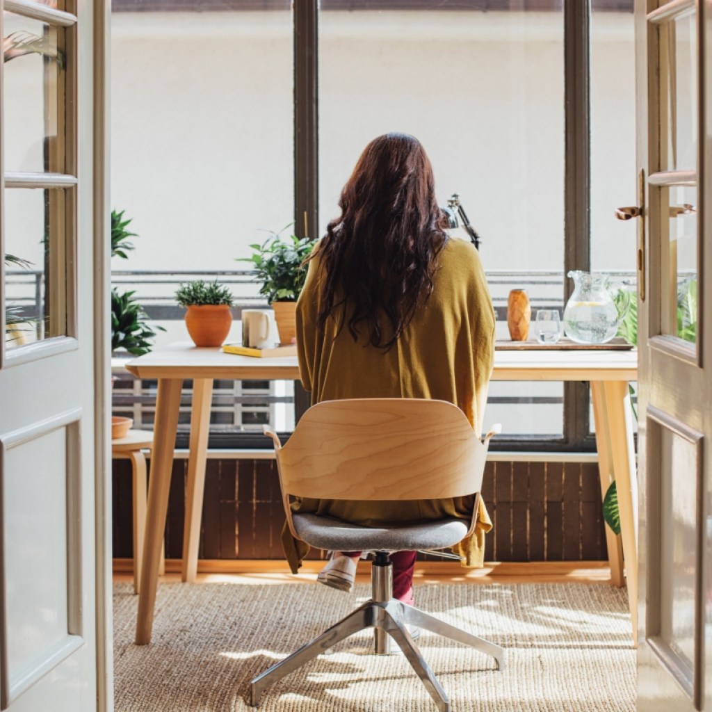 woman sitting at a desk in a mobile office chair