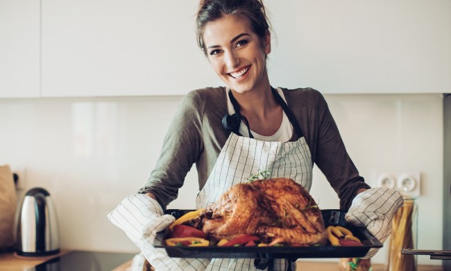 Woman holding a turkey on a platter