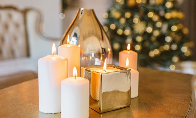 Candles and glass vase on coffee table for Christmas decor