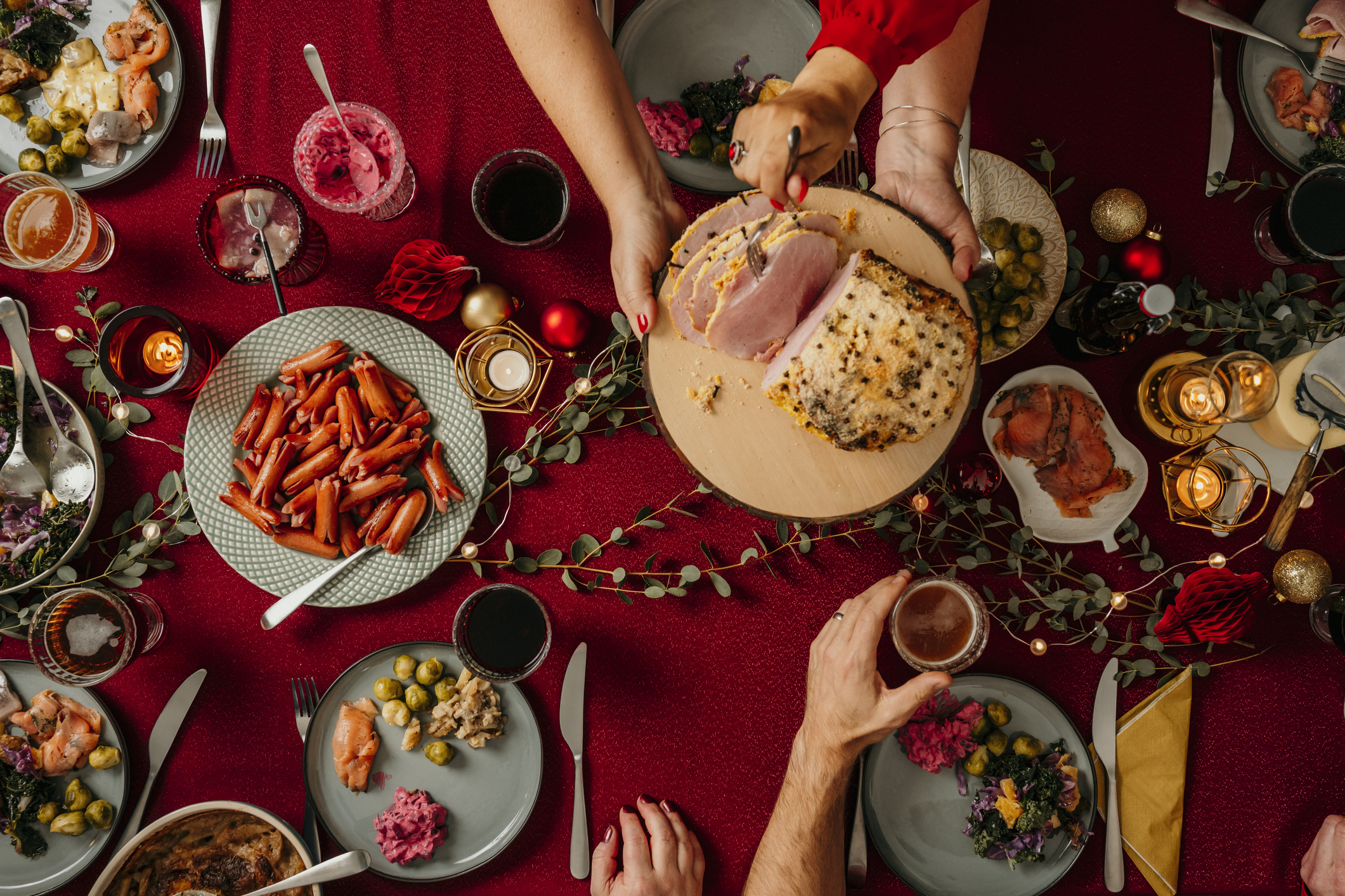 Christmas dinner from above with red table cloth and candles