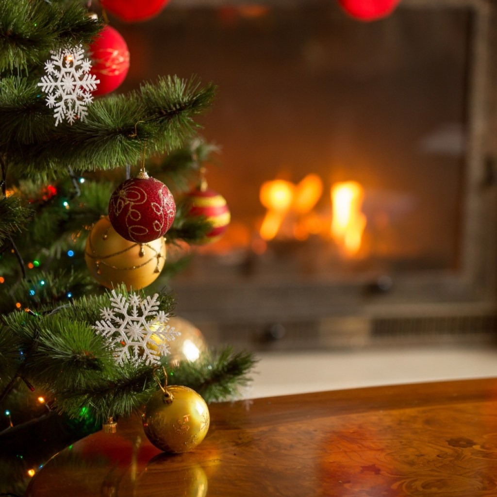 Close-up of Christmas tree ornaments in front of fireplace