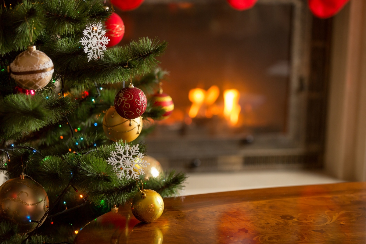 Close-up of Christmas tree ornaments in front of fireplace