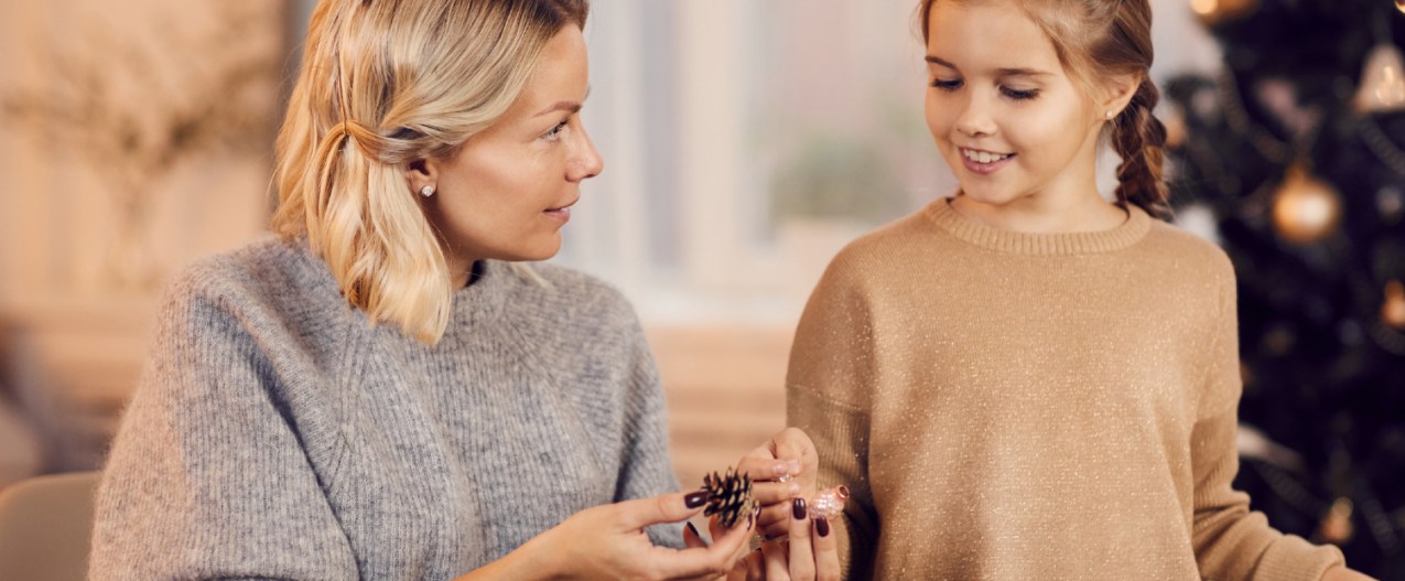 Woman and child DIYing Christmas decorations