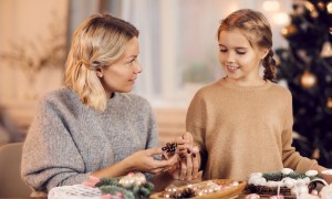 Woman and child DIYing Christmas decorations