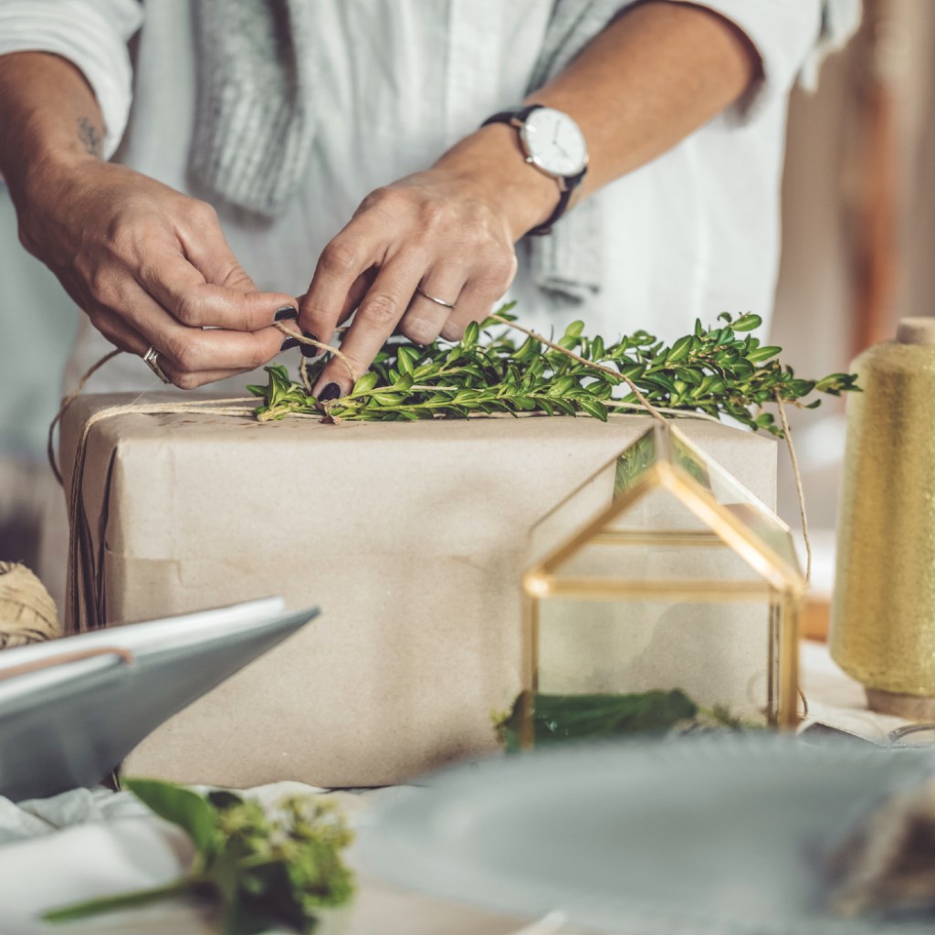 Wrapping gifts with greenery as finishing touch
