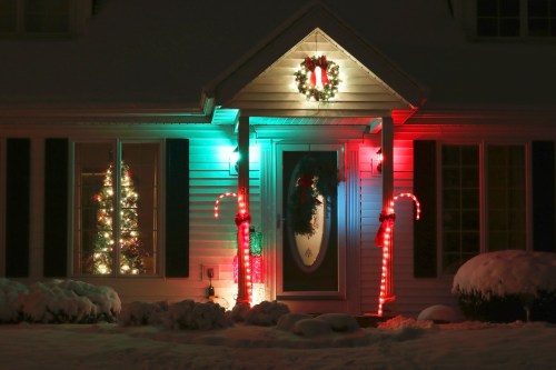 Front yard of home with lit candy canes for Christmas