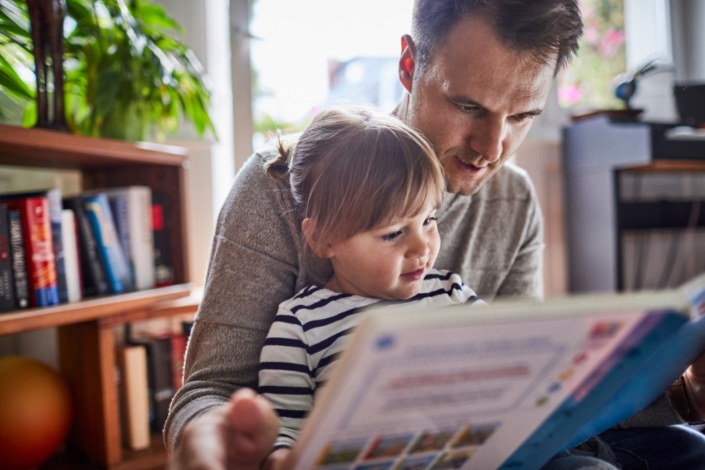 Father and daughter reading together at home