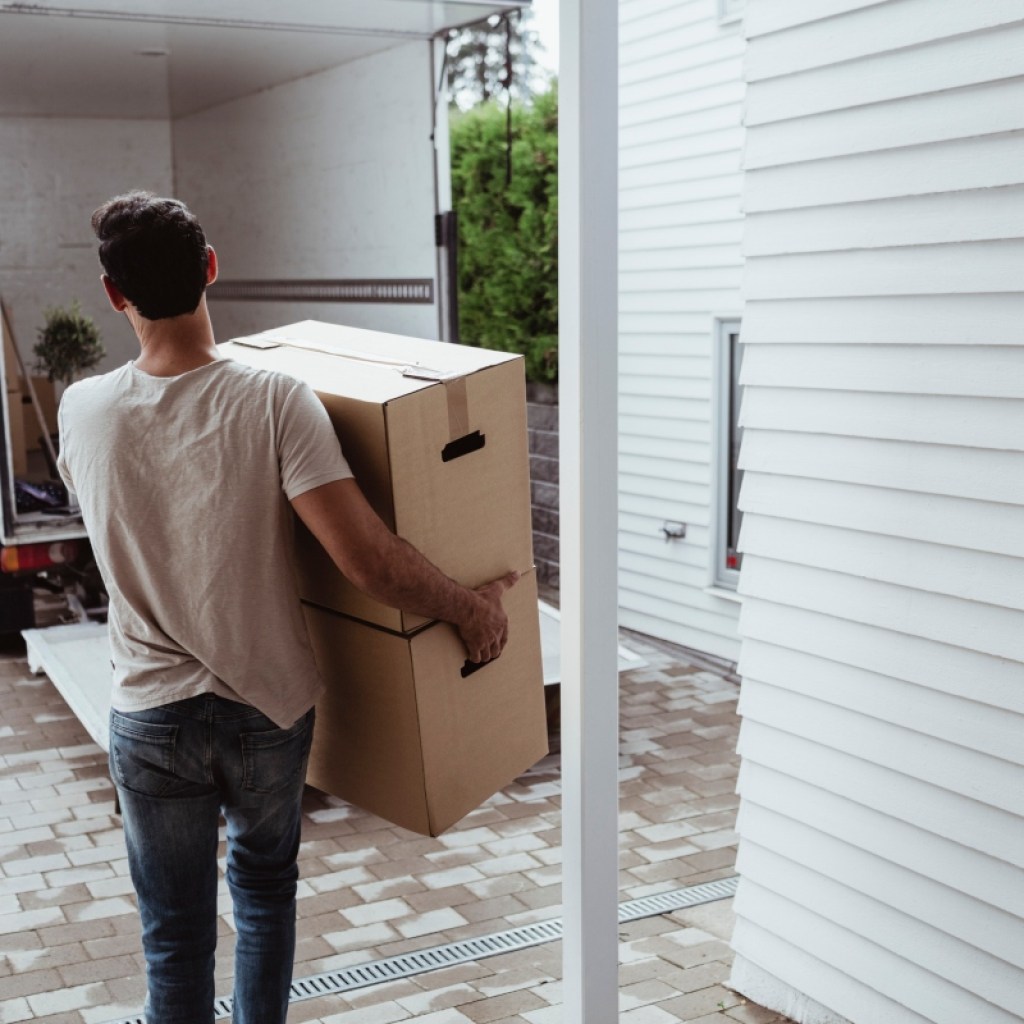man carrying boxes to a moving truck