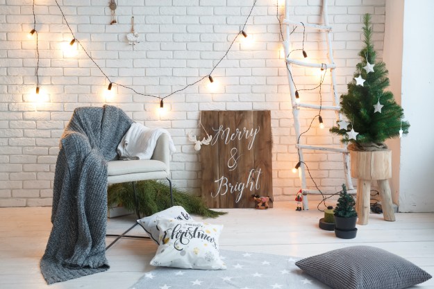 Christmas decorations in house with wall sign on floor