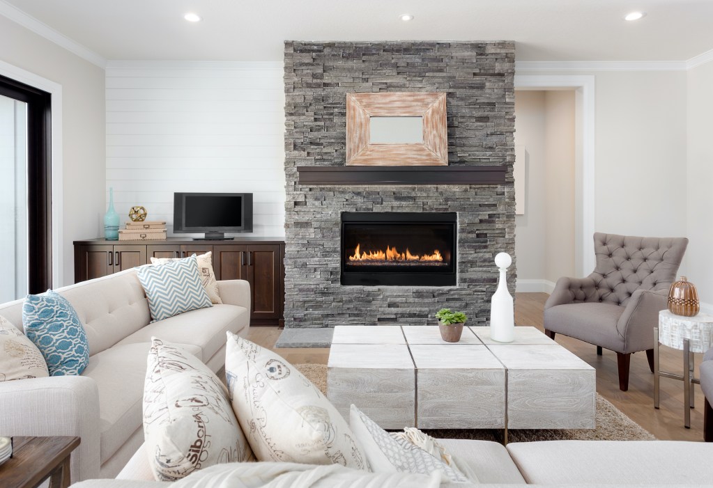 Living room with can lights and fireplace