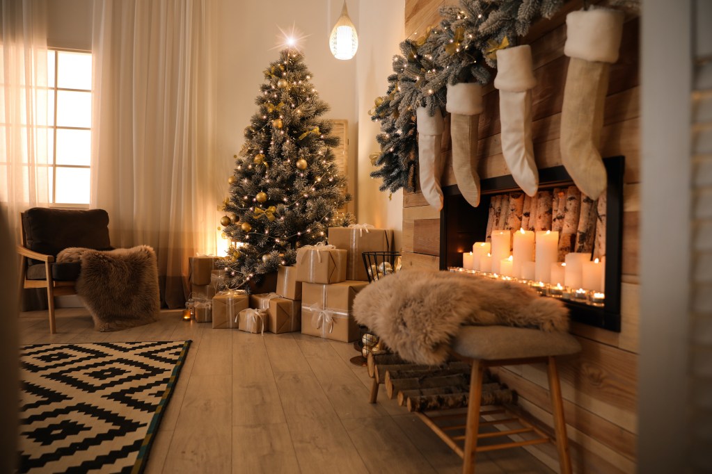 Stylish room interior with beautiful Christmas tree and decorative fireplace