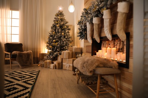 Stylish room interior with a beautiful Christmas tree and decorative fireplace