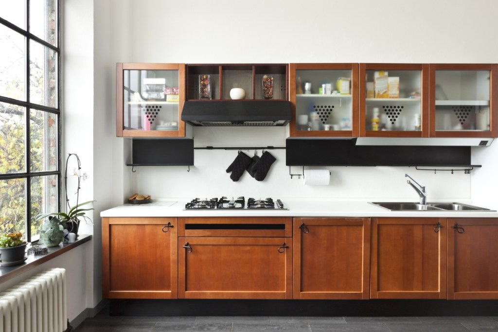 Modern kitchen with red oak cabinets and white countertops