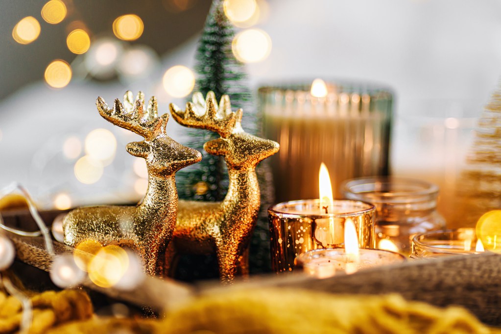 Burning candles and Christmas decorations on wooden tray