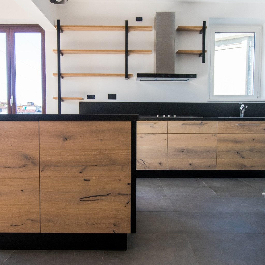 modern black and white kitchen with oak cabinets