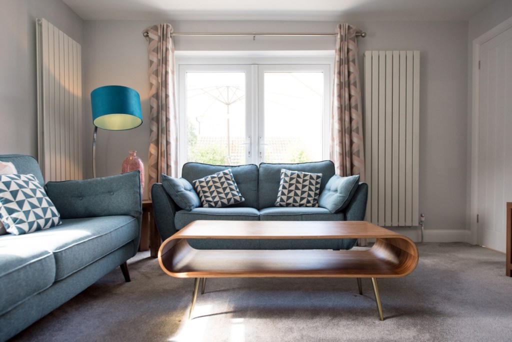 Retro living room with curved coffee table and blue sofas