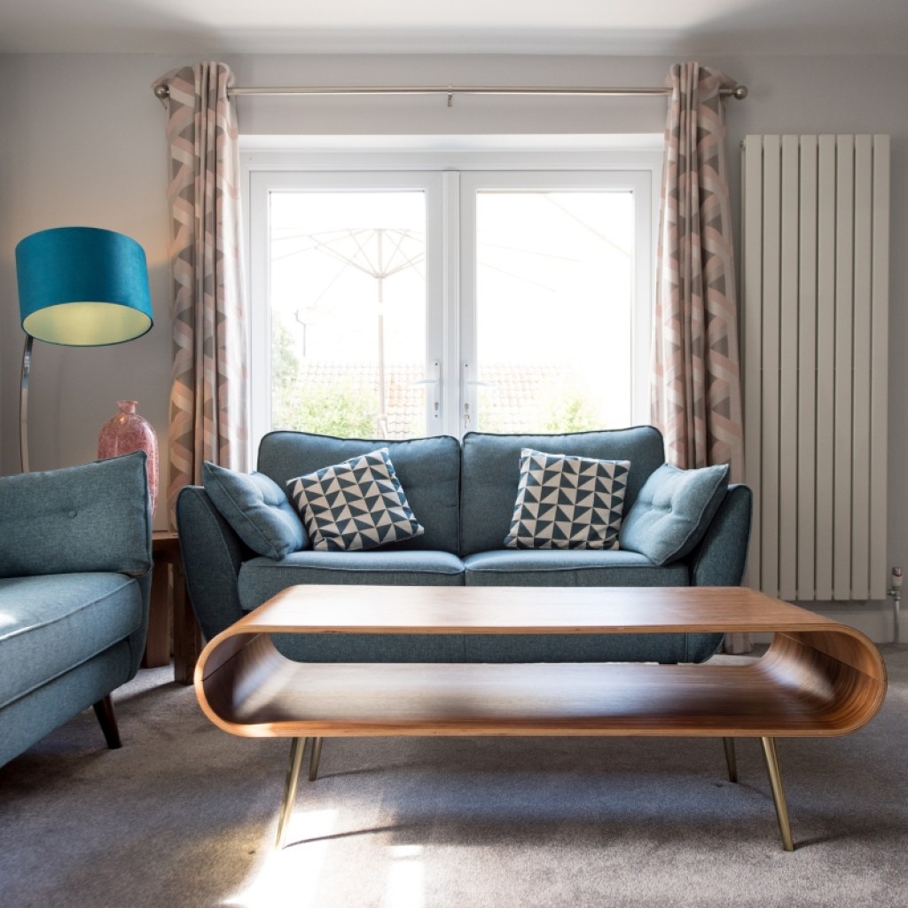Retro living room with curved coffee table and blue sofas