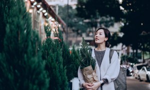 Woman shopping for live Christmas trees