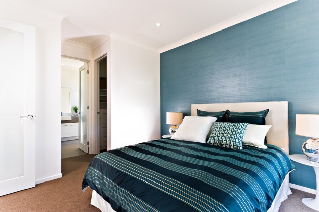 Bedroom with dark wall behind king bed