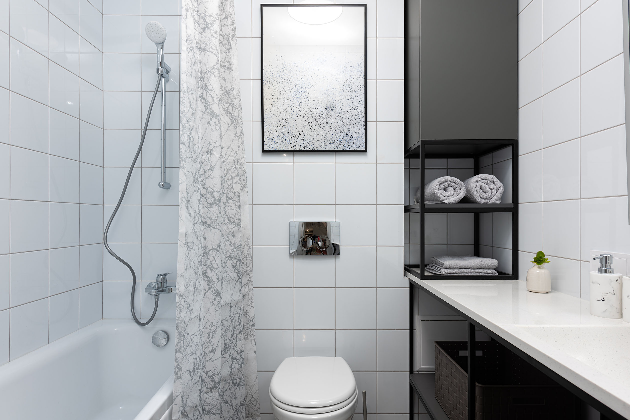 Wall art hanging in the bathroom above the toilet